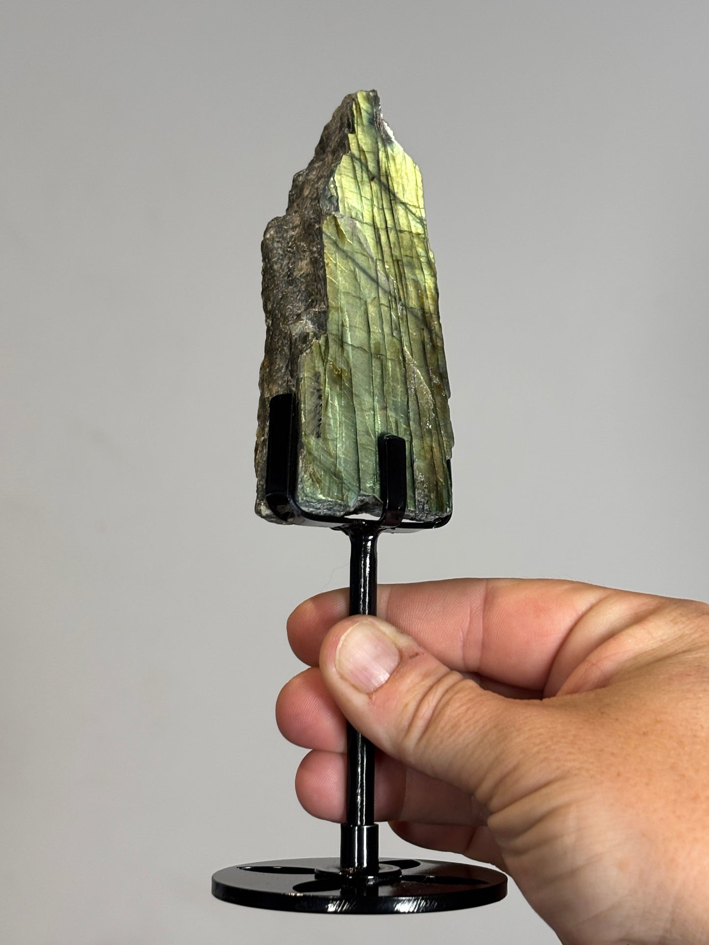 Half polished half raw Labradorite on metal stand